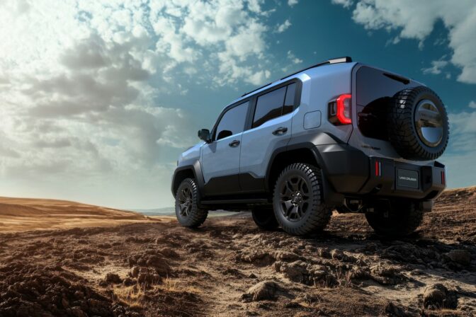A white jeep is parked on a dirt road. The jeep has a large carg