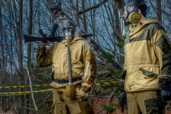 An armed stalker in overalls and a gas mask in a dangerous radioactive zone.