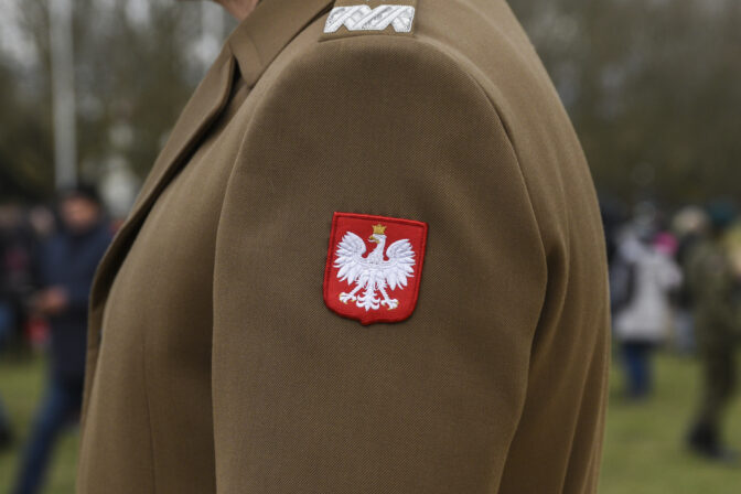 The emblem of Poland on the uniform of a soldier of the Polish army.
