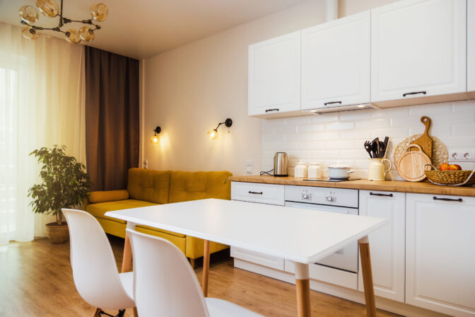 Mockup, empty table in bright kitchen interior. Copy paste for your design