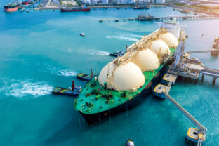 LNG (Liquefied natural gas) tanker anchored in Gas terminal gas tanks for storage. Oil Crude Gas Tanker Ship. LPG at Tanker Bay Petroleum Chemical or Methane freighter export import transportation