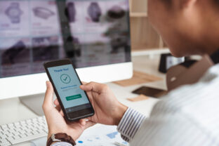 Man's,Hands,Holding,Smartphone,And,Successful,Online,Payment.,Mobile,Wallet