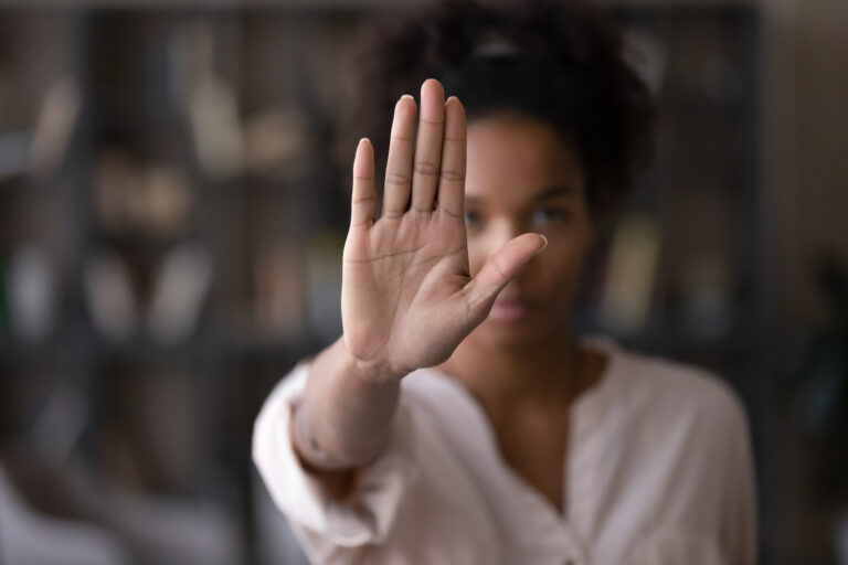 Serious african american woman protesting against bullying.