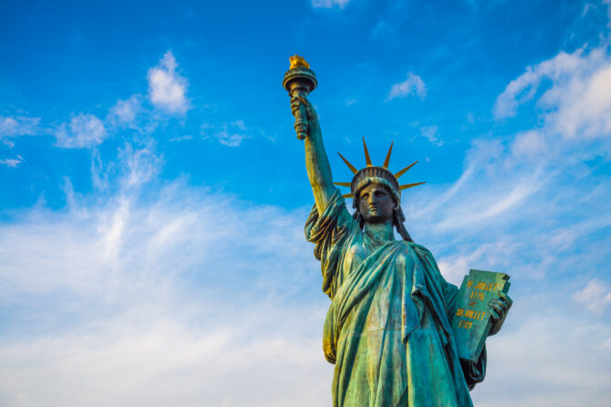 Statue of liberty and rainbow bridge landmark in Odaiba, Tokyo Japan.