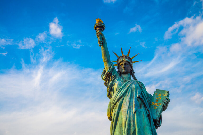 Statue of liberty and rainbow bridge landmark in Odaiba, Tokyo Japan.