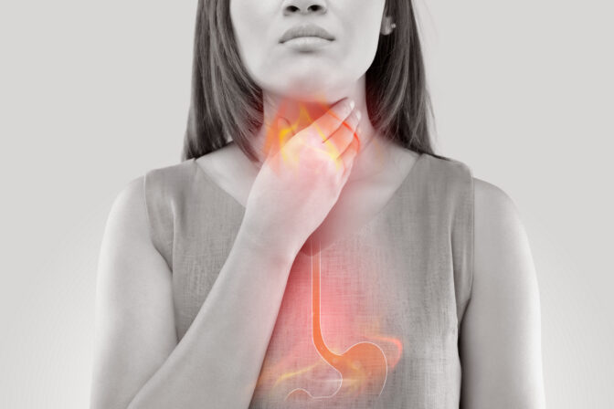 Woman Suffering From Acid Reflux Or Heartburn Isolated On White Background