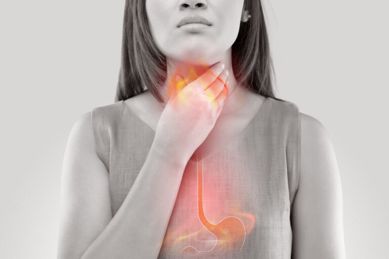 Woman Suffering From Acid Reflux Or Heartburn Isolated On White Background