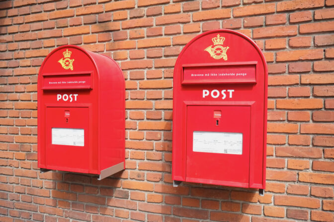 Red mail boxes on brick wall