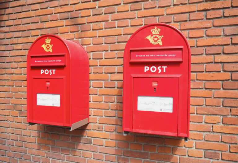 Red mail boxes on brick wall