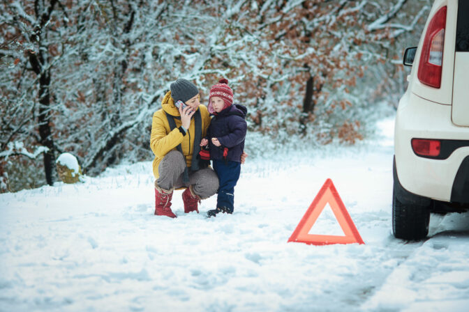 Woman with a child on the winter road