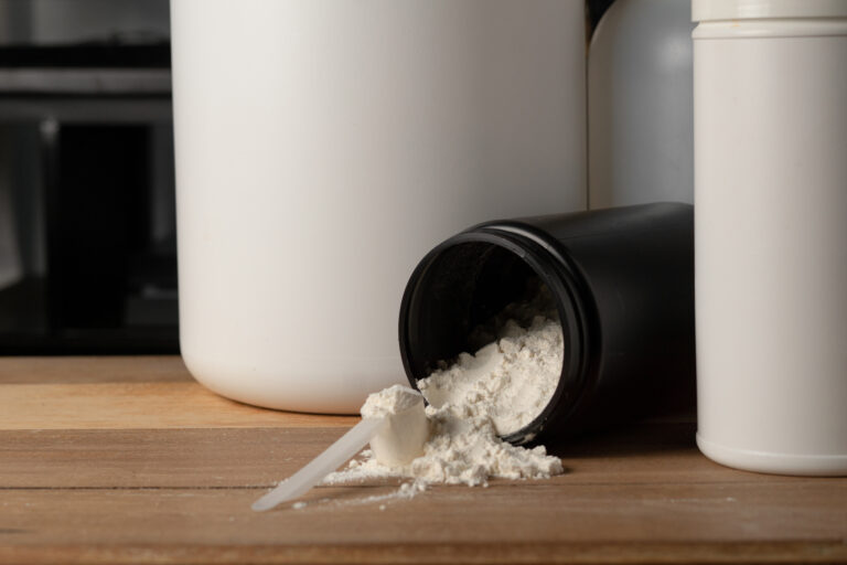 A scoop on top of a mountain of creatine powder,. muscle building concept.