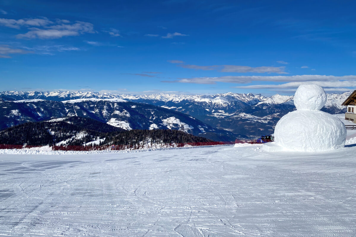 Panoramic view from top of Kronplatz mountain (ital. Plan de corones) with giant snowman