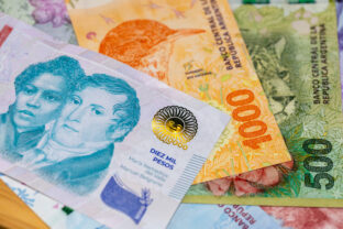 Argentina pesos. 10,000 peso banknote against the background of other Argentine money. Financial business concept. close up