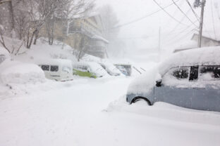 Cars blocked by heavy snowfall in the ski resort village of Madarao in Nagano, Japan