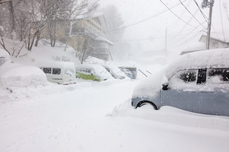 Cars blocked by heavy snowfall in the ski resort village of Madarao in Nagano, Japan