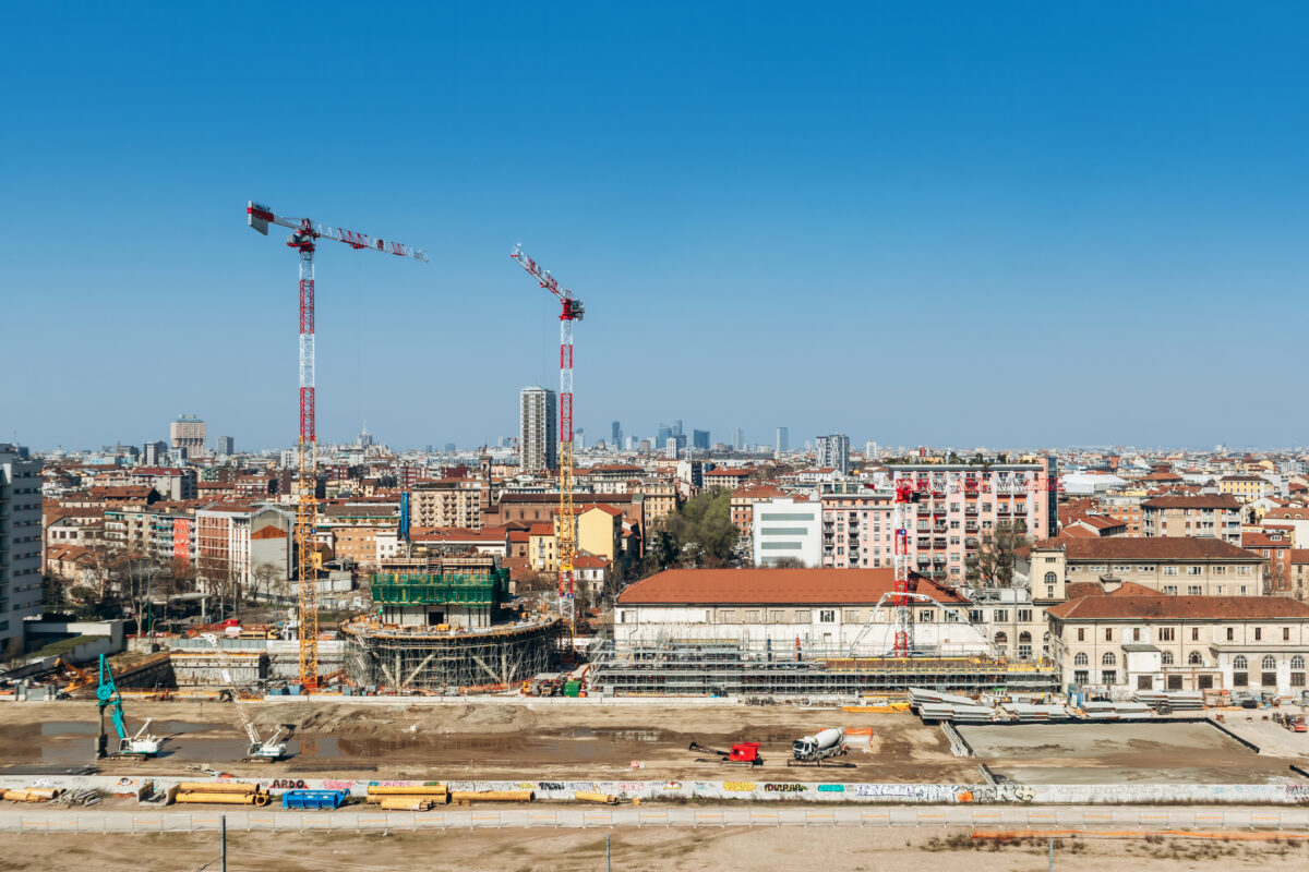 Panoramic cityscape from Fondazione Prada window with Olympic Village construction site and Milan skyline