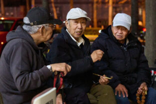 Elderly men talking on a bench in Beijing, April 2025