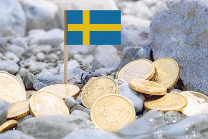 Flag of Sweden and euro currency coins on the riverbank.
