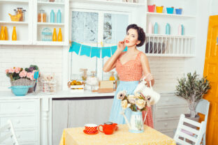 Pin up style. Girl with a jug of flowers.