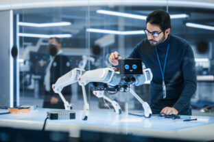 Portrait of Hispanic Engineer Using a Screwdriver While Building and Developing a Robot Dog Concept. Multiethnic Specialist Working in High Tech Research Laboratory with Modern Equipment.