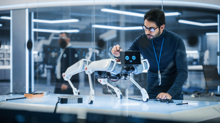 Portrait of Hispanic Engineer Using a Screwdriver While Building and Developing a Robot Dog Concept. Multiethnic Specialist Working in High Tech Research Laboratory with Modern Equipment.