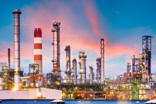 Oil refinery and plant and tower column of Petrochemistry industry in oil and gas industrial with cloud orange sky the sunrise background