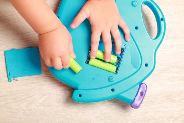 Hand the child put the batteries in the red toy