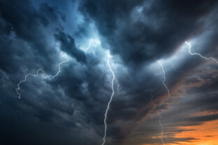 Lightning thunderstorm flash over the night sky.
