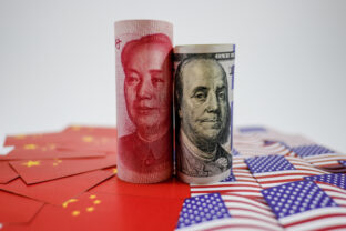 China yuan banknote on China flags and US dollar banknote on united states flags for trade war