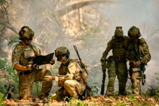 The army stop and discuss together before go to next place during fighting in the forest