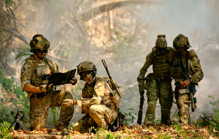 The army stop and discuss together before go to next place during fighting in the forest