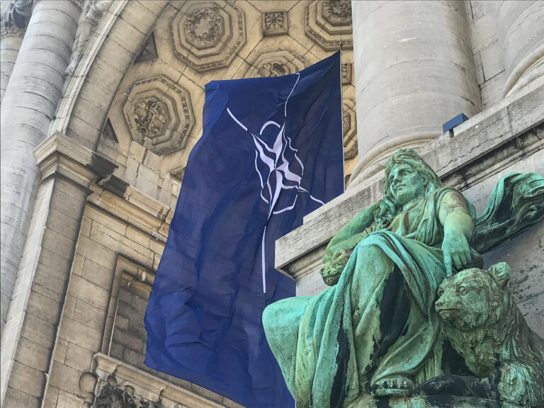 NATO flag between the arcades of the Cinquantenaire