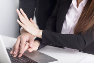 Business man touching woman hand feeling disgusted and uncomfortable. Sexual harassment inappropriate at office