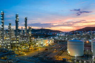 Aerial view oil and gas tank with oil refinery background at night, Glitter lighting of petrochemical plant with night, Manufacturing of petroleum, Products tank in petrochemical plant.