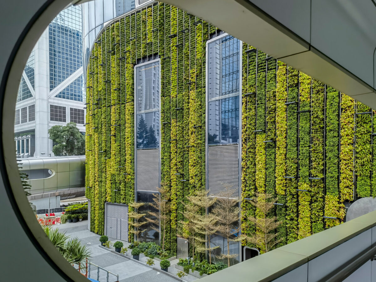 Close up view of a vibrant green wall on a modern building in Hong Kong's central business district. A glimpse of travel and urban architecture.