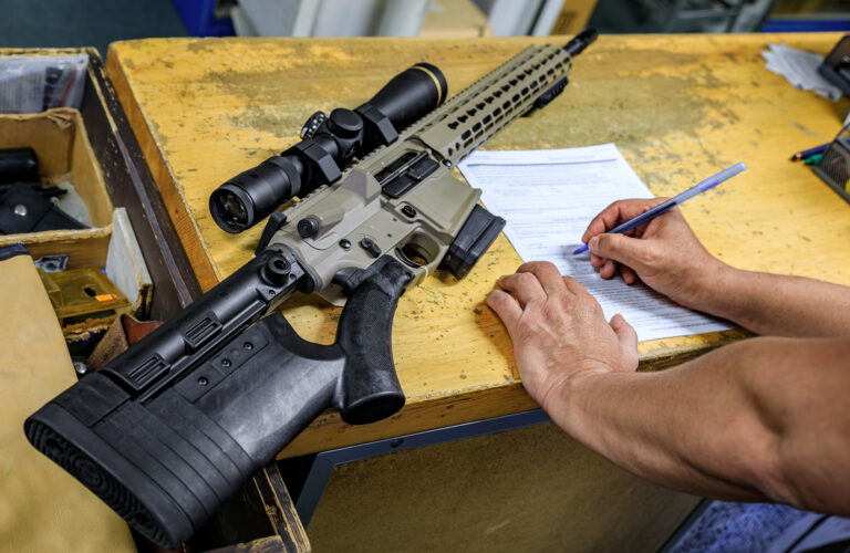 California gun shop: buyer signs paperwork for an AR 15 rifle, state regulations