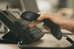 Headset and dialing a telephone in call center office concept , call center and customer service help desk