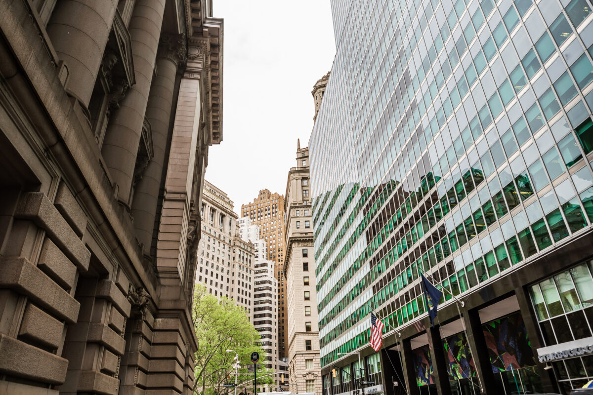 New York City street with modern office building and historic architecture, Manhattan business and financial district cityscape.