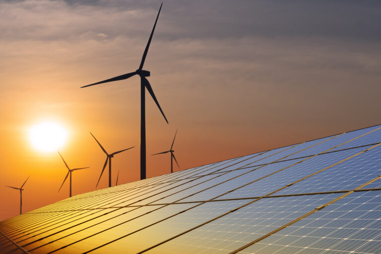 Solar panels with wind turbine at sunset. concept clean energy. Energy supply, wind turbine,eolic turbine, distribution of energy,Powerplant,energy transmission,high voltage supply concept