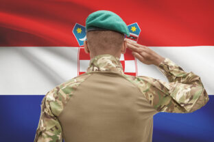 Dark skinned soldier with flag on background - Croatia