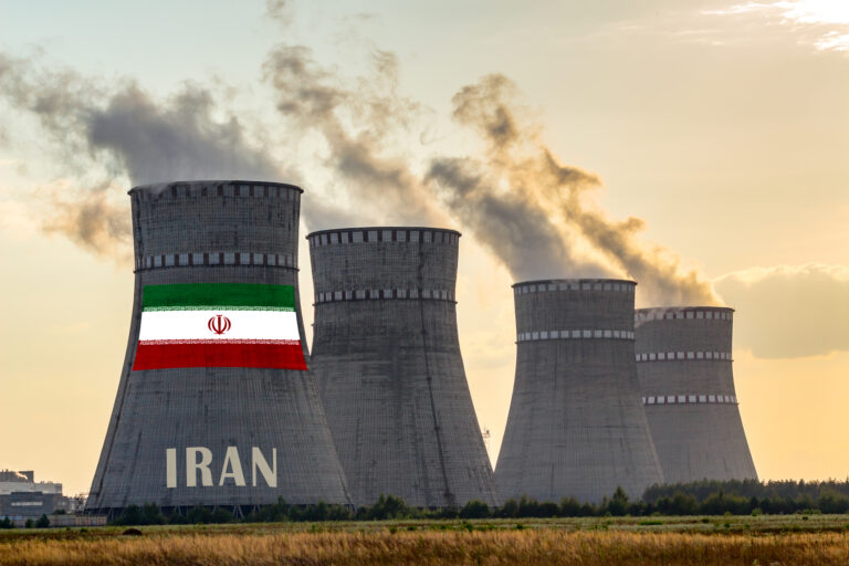 Nuclear plant chimneys displaying flag of Iran with according text. Energy pollution accidents in a country concept.