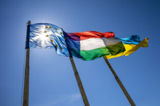 Flags of Hungary Ukraine and European Union waving on pole against blue sky