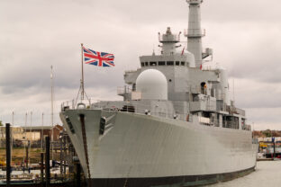 Photograph of a British naval ship at port