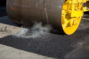 Road roller compacting asphalt