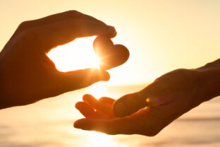 Hand giving heart love help support kindness