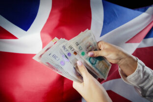 UK flag background. Woman counting GBP money pounds sterling. Credits, raising tariffs in Great Britain, traveling costs, financial concept.