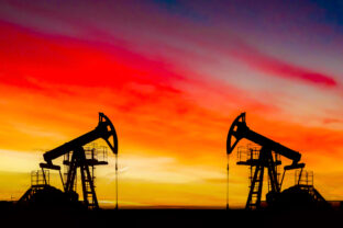 Oil drilling derricks at desert oilfield. Crude oil production from the ground. Oilfield services contractor. Oil drill rig and pump jack. Petroleum production, natural gas, liquids, NGL, additive.