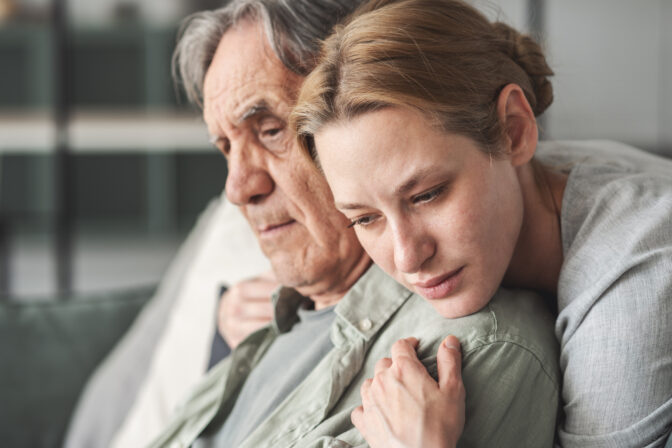 Daughter hugging her father sadly