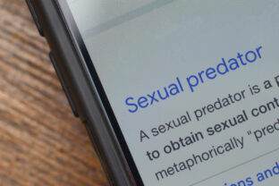 Smartphone Displaying Sexual Predator Definition and Information