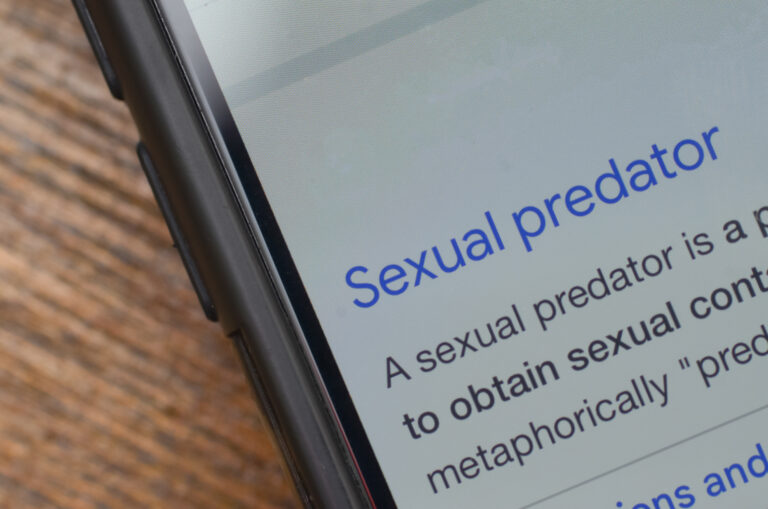 Smartphone Displaying Sexual Predator Definition and Information